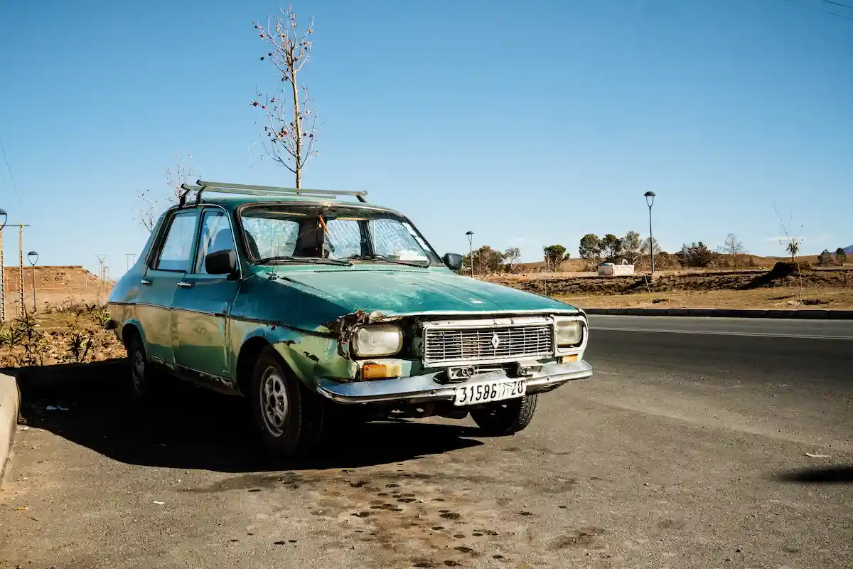 Train Travel In Morocco - It's So Easy a green car parked on a road in morocco